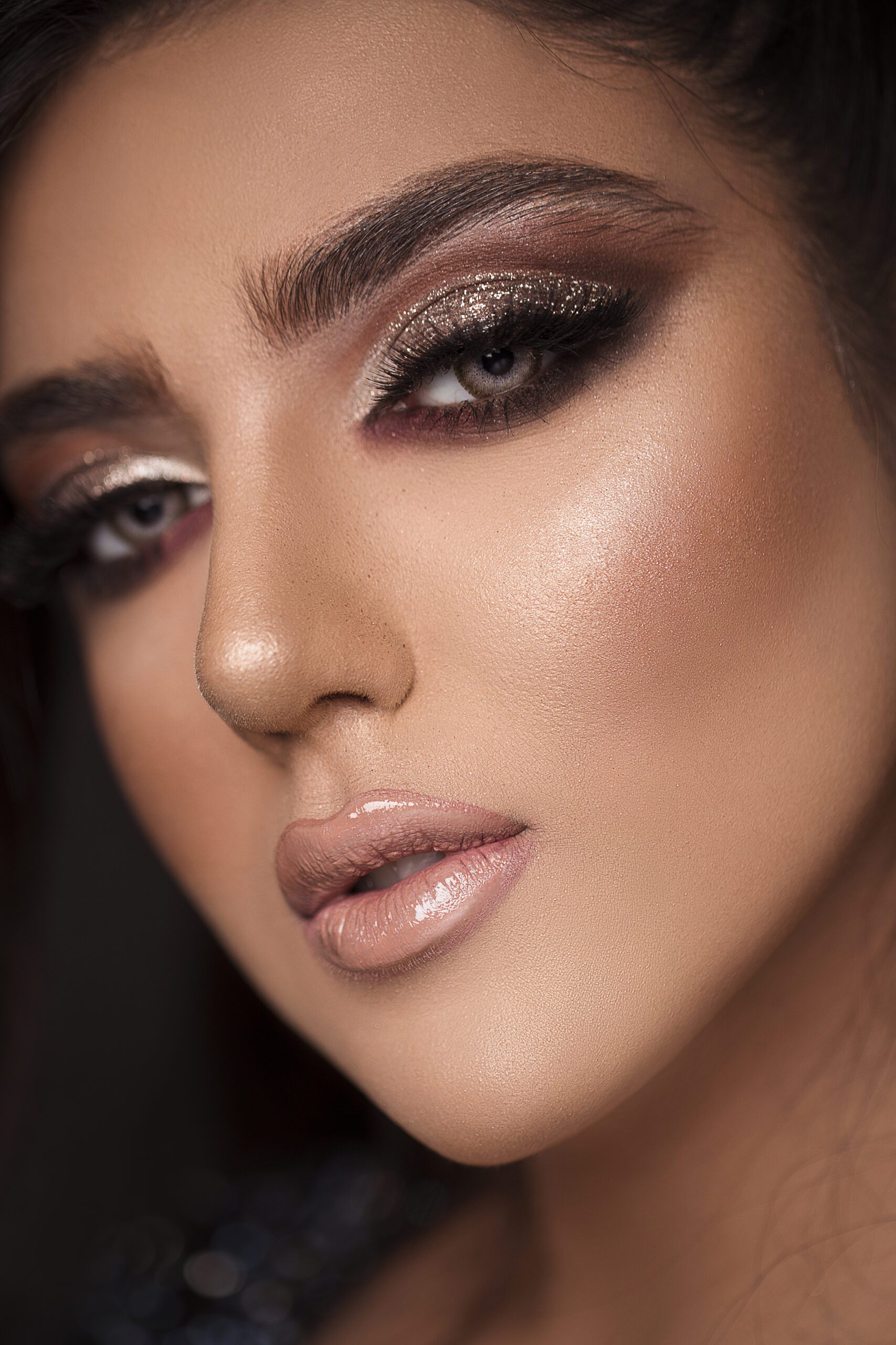 Model in smokey eyes and pink glossy lipstick